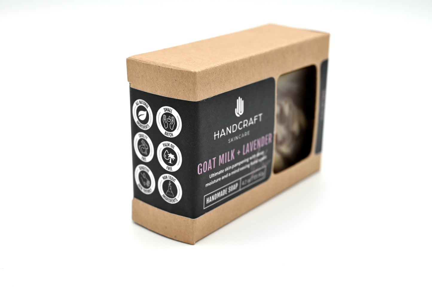 packaged purple lavender and white swirled goat milk and lavender soap in a Kraft box with a black label and white logos stating all natural ingredients, small batch, cruelty free, palm oil free, sensitive skin friendly and non toxic ingredients