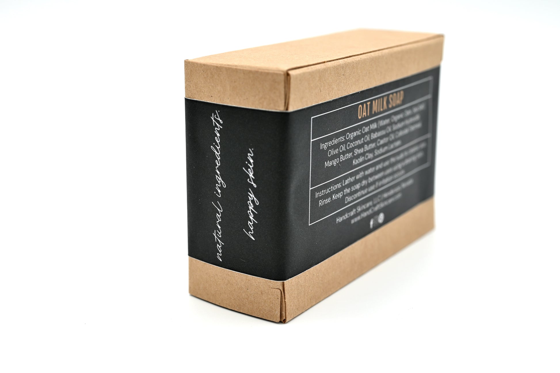 packaged taupe colored oat milk soap in a Kraft box with a black label and white writing stating natural ingredients happy skin