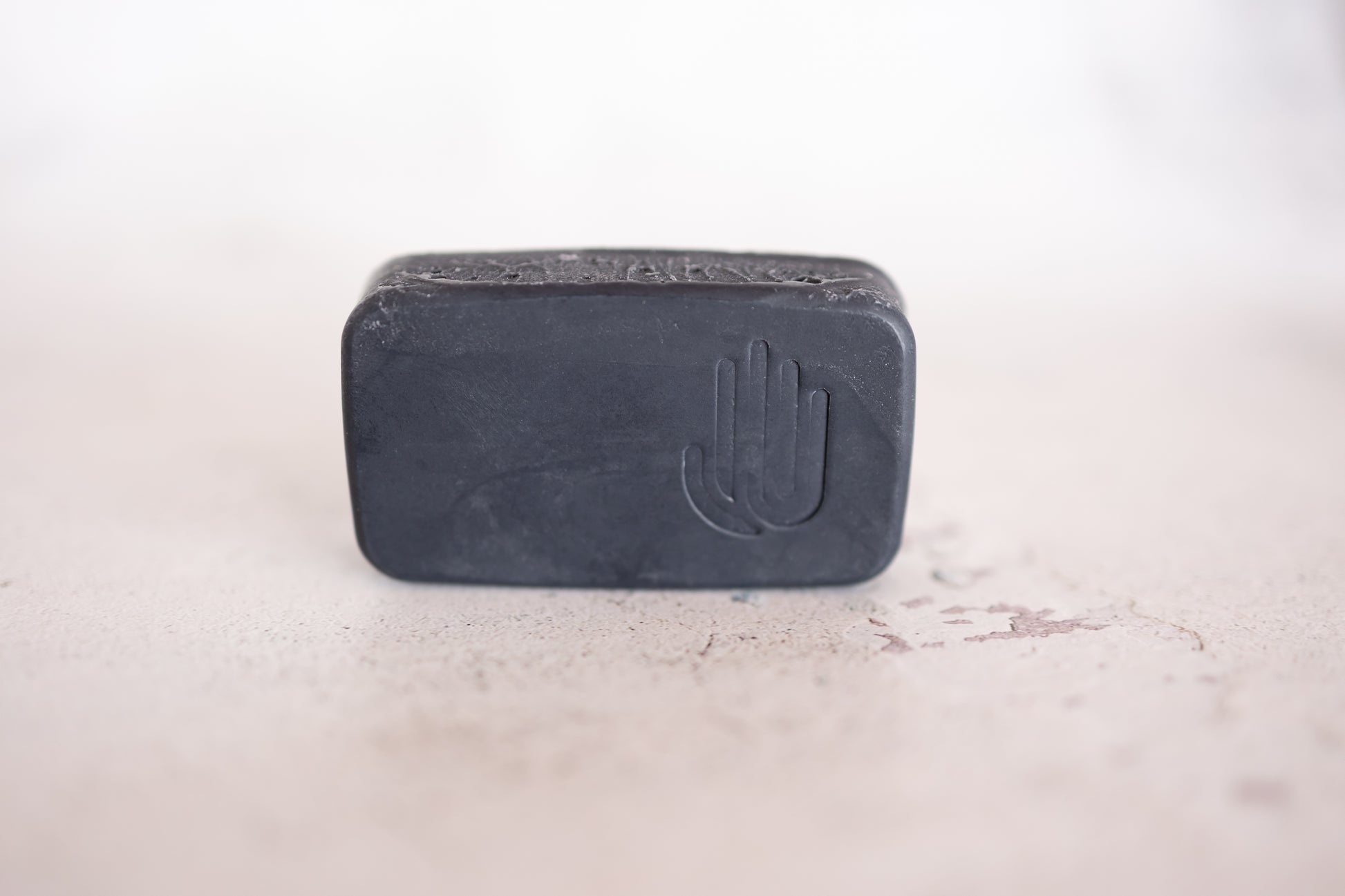 black tea tree charcoal square soap on a white background